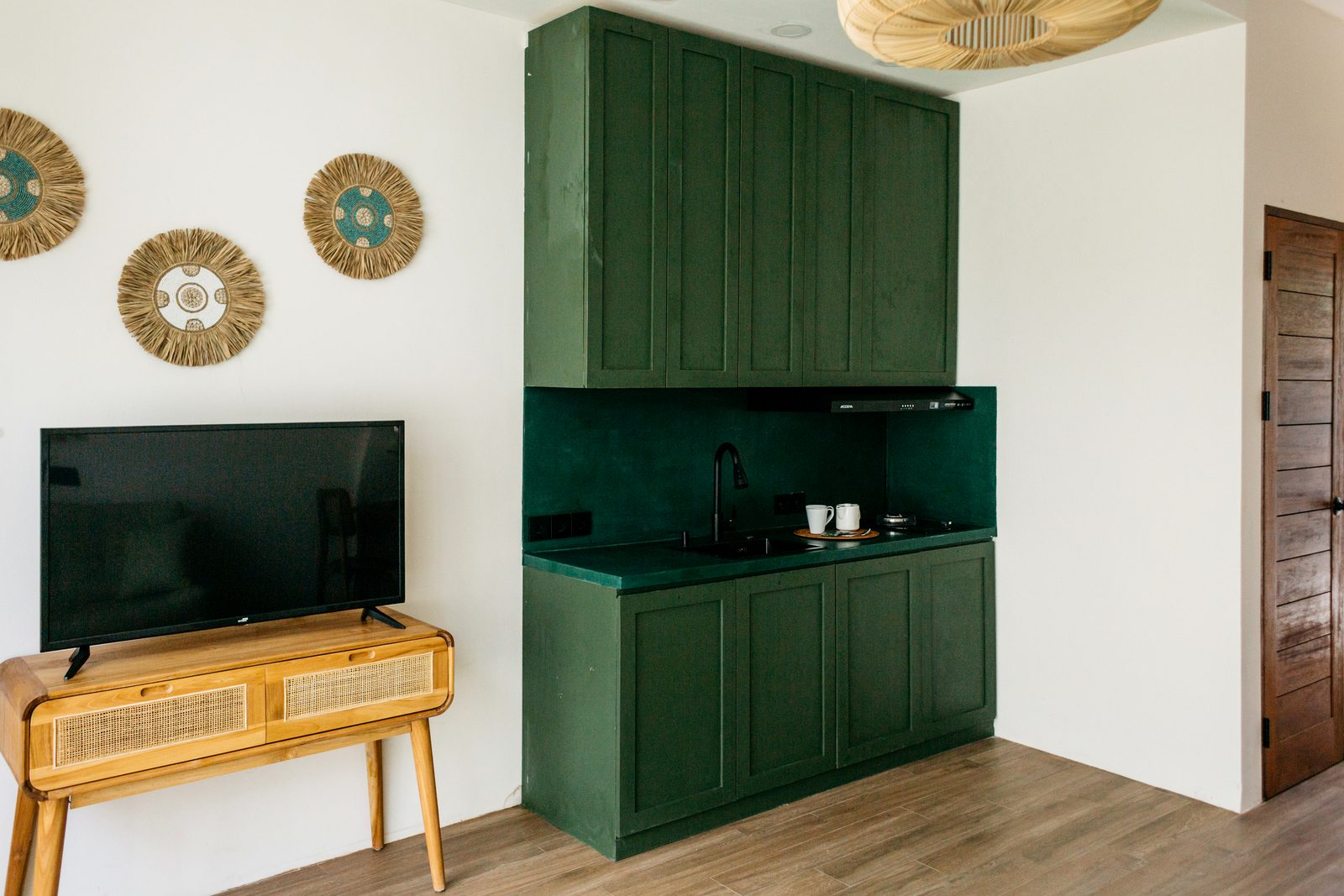 Signature emerald-green fitted kitchen — boutique villa, Santara Villas Ubud