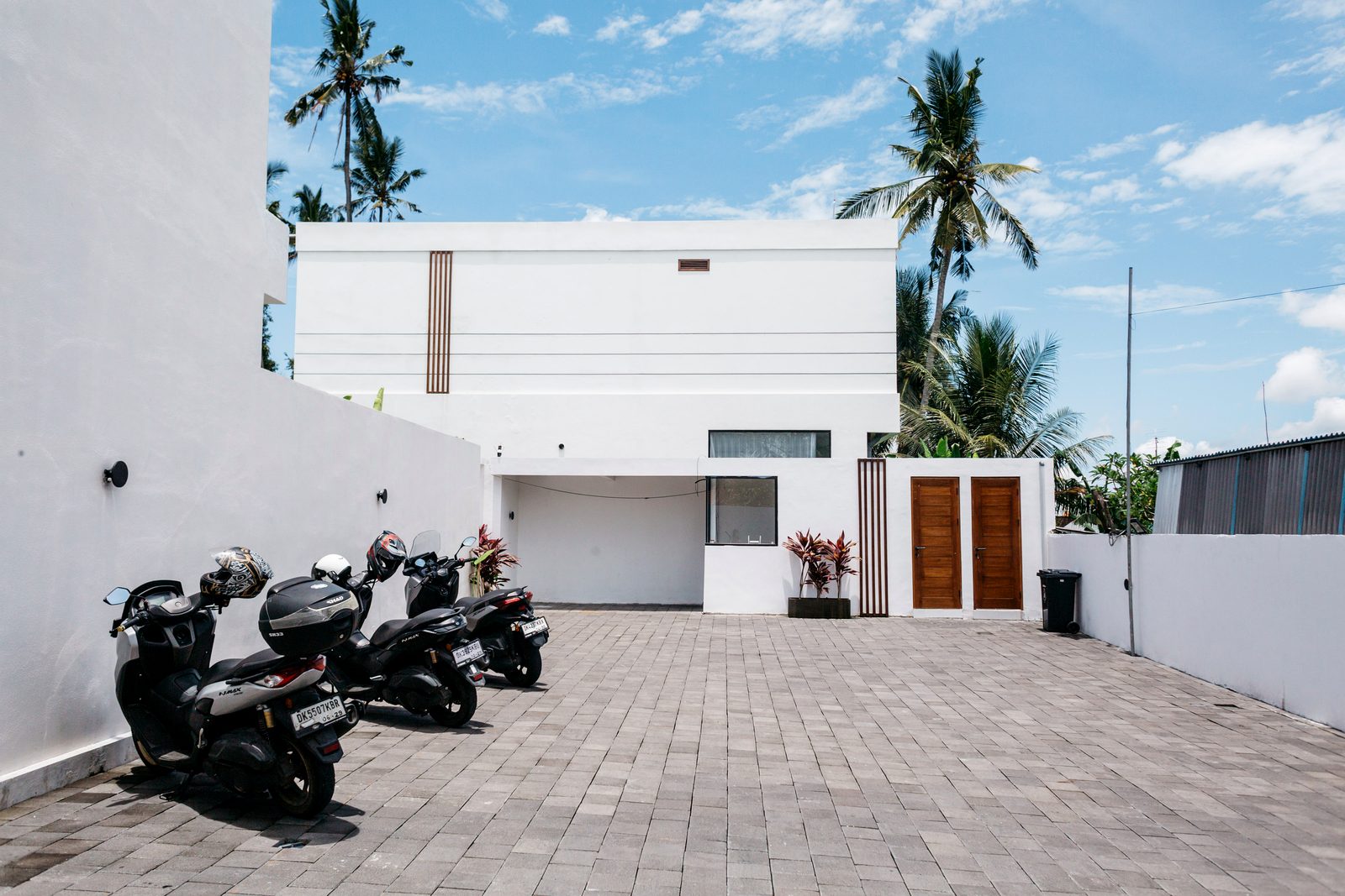 Private gated paved parking courtyard with teak entrance doors — Santara Villas Resort, Ubud Bali