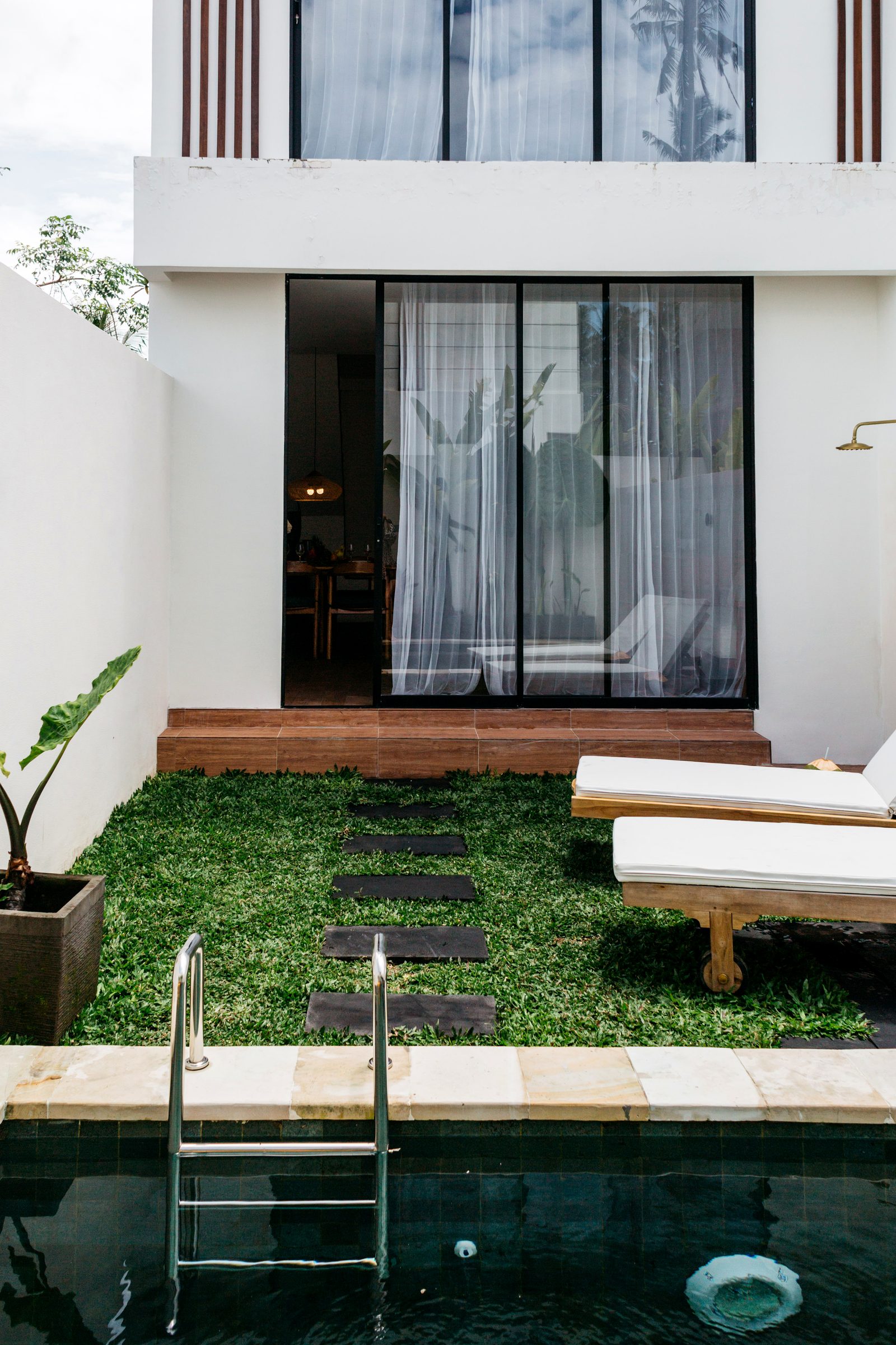 Private pool and sun lounger off floor-to-ceiling glass villa — boutique resort, Ubud Bali